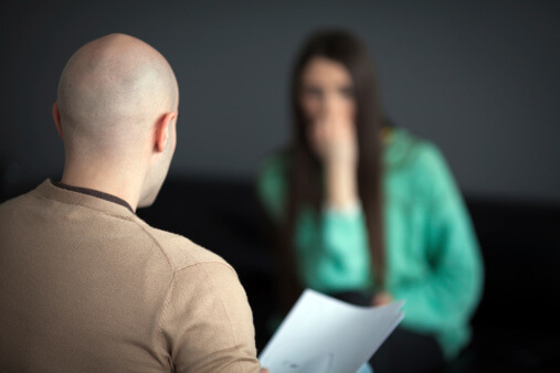 woman sits down with doctor to learn how to stop using drugs safely