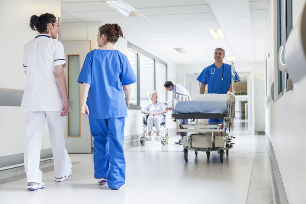 a nurse rolls a gurney down the hall for a person suffering from a drug overdose