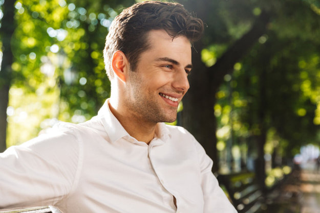 a man smiles as he enjoys sober living