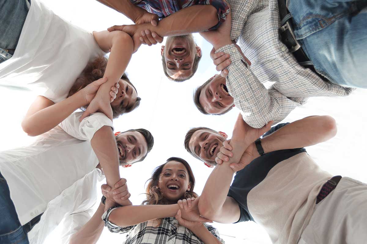 people with linked arms in a circle at portland drug rehab center