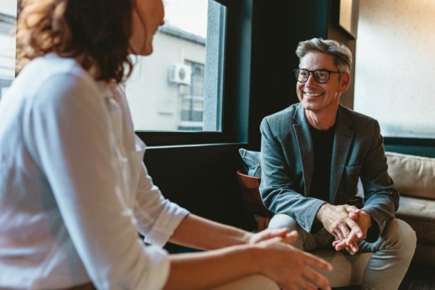 woman talking to therapist in alcohol addiction treatment center