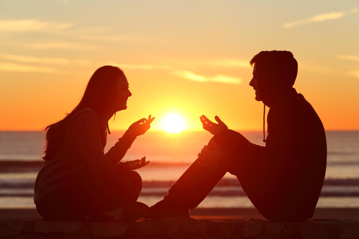 couple sitting during sunset one has a heroin addiction