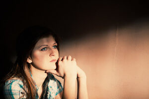 woman contemplates rehab steps by a wall