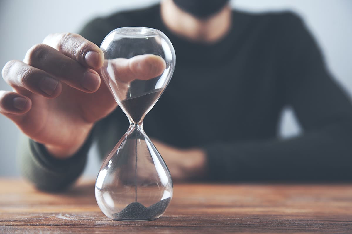 man using hourglass to practice patience