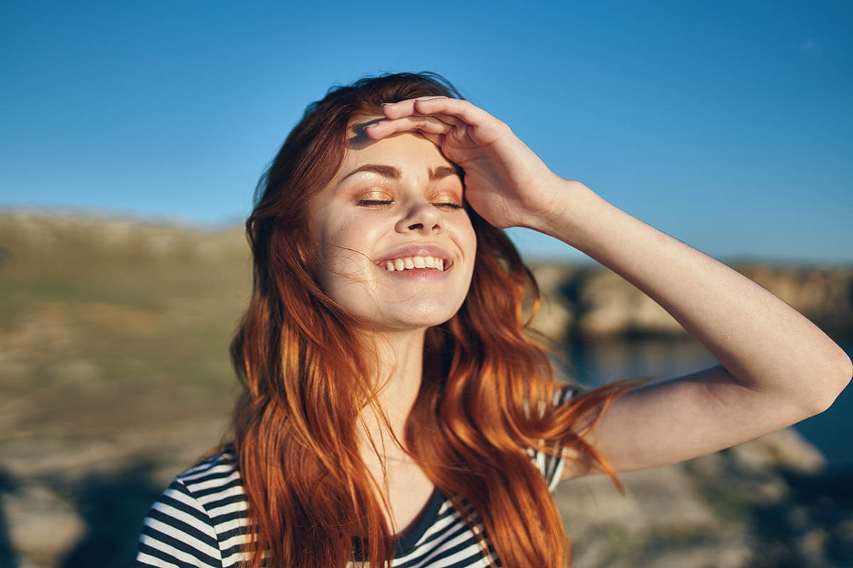 woman smiling because she is using tips for maintaining your sobriety