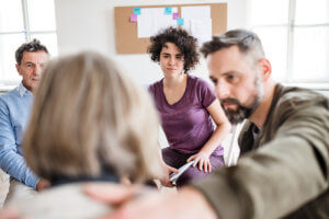 a group of friends talk to someone about attending a heroin rehab center near salem