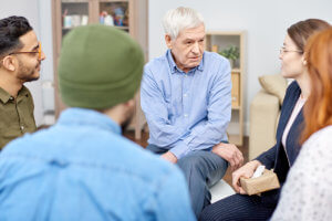 an older gentleman talks to a group of people about attending a heroin rehab center near Springfield