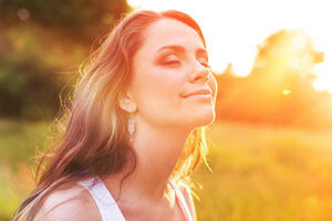 a woman smiles as she gets treatment at a heroin rehab center near Arlington