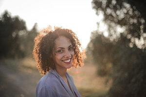 a woman outside smiling at a heroin rehab center near bonney lake