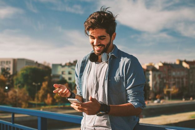 Man reading about life skills for recovery on his smartphone