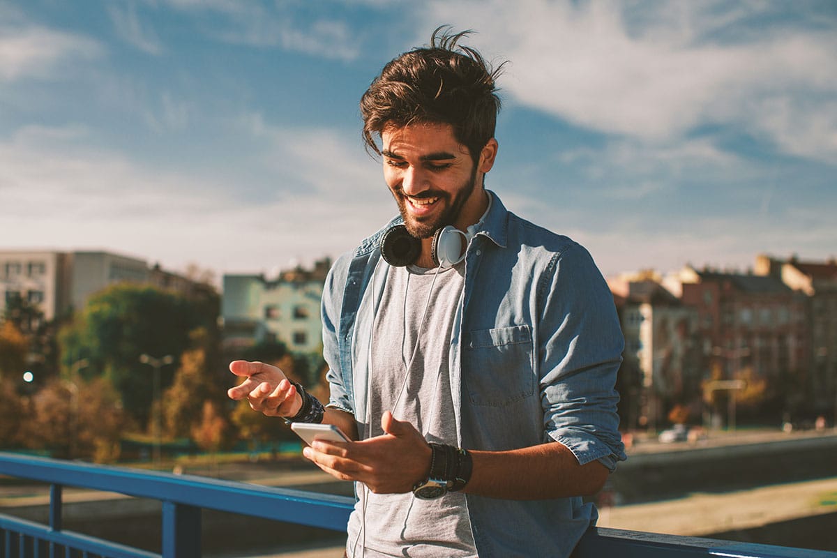 Man reading about life skills for recovery on his smartphone