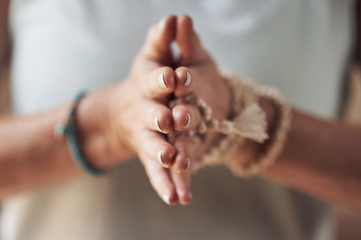 woman with palms together in holistic therapy program