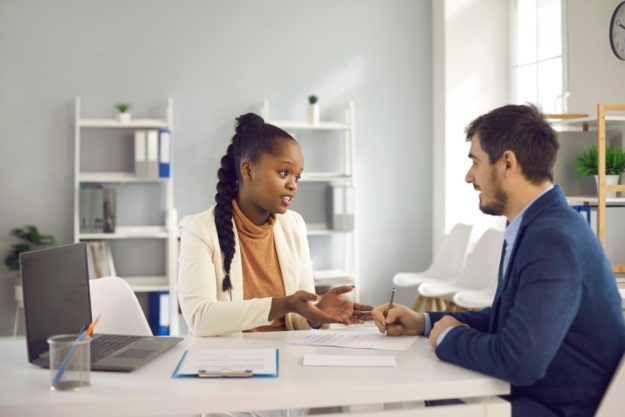 Two people discussing the costs for addiction treatment