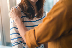 Person being comforted in prescription drug addiction rehab