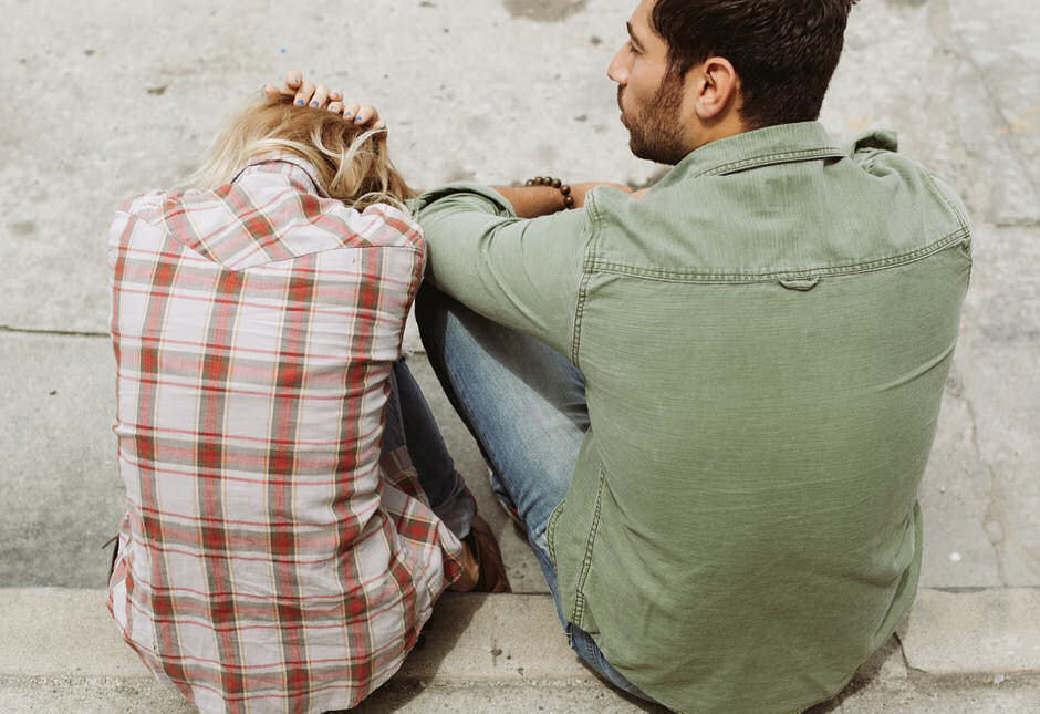 spouses sitting together and struggling with addiction