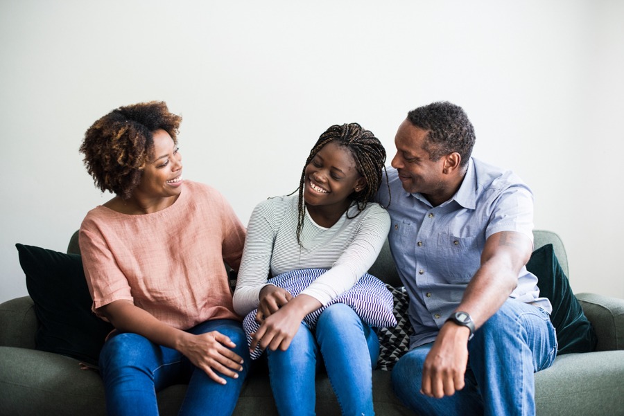 parents sitting with their young adult who has recovered from substance use disorder