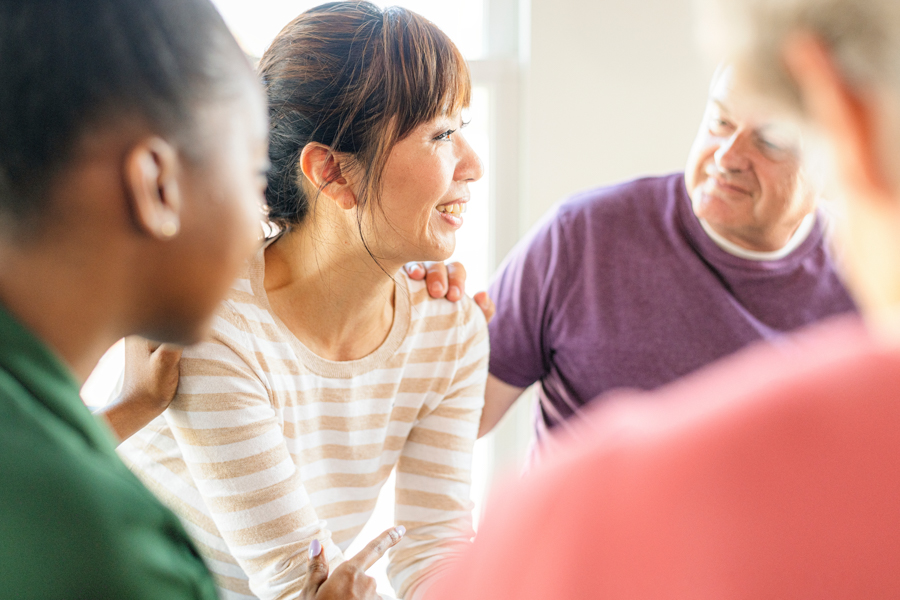 woman receiving support from peer in group therapy in portland rehab