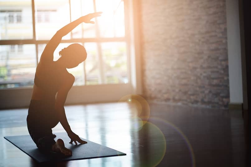 woman practicing step 11 by doing yoga