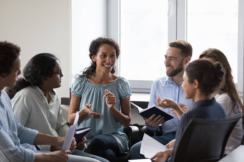 group of people smiling in recovery meeting