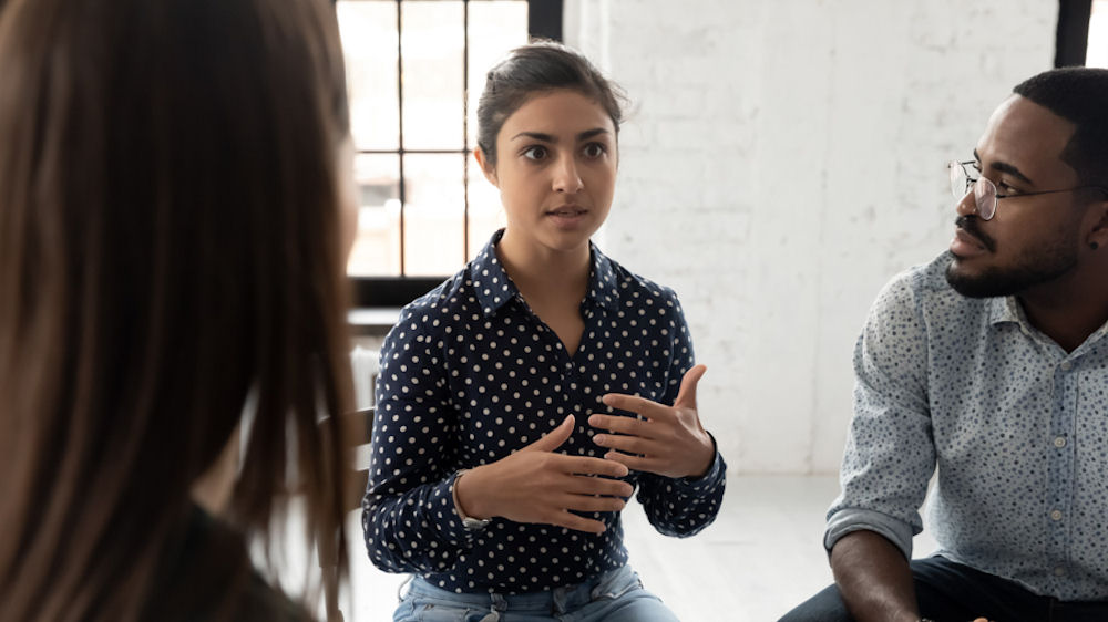 woman discussing addiction with group