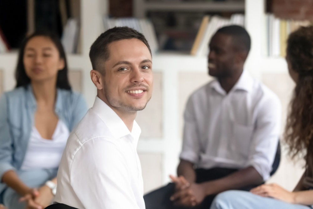 man smiling in therapy