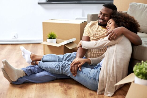 happy sober couple unpacking boxes for new home