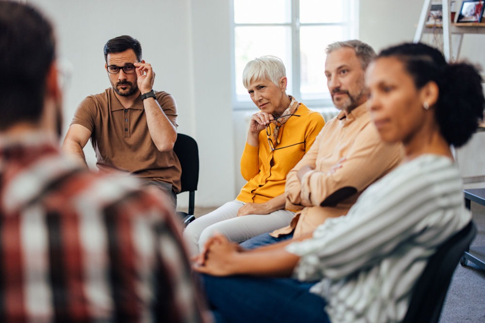 group intently listening during therapy session