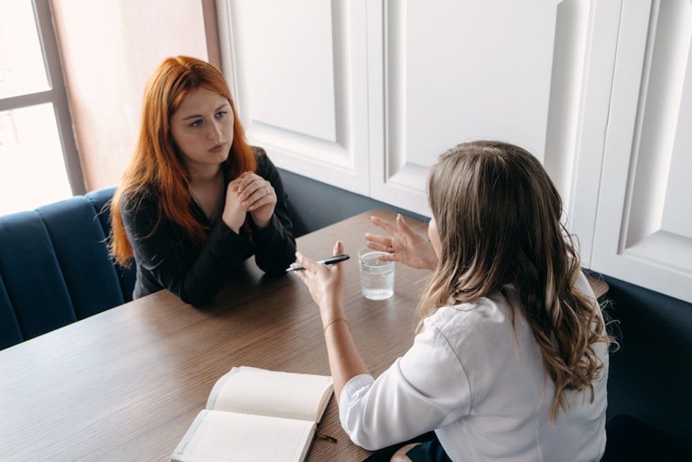 two women discussing addiction topic