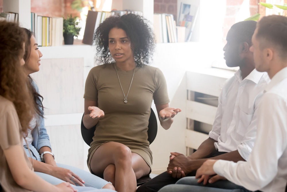 woman adressing a group in an office setting